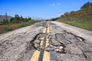 a-road-filled-with-pot-holes-because-of-poor-roadway-design-construction-and-maintenance