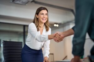 A woman shakes her attorney’s hand. Having a successful relationship with your personal injury lawyer requires mutual trust, respect, and open communication.